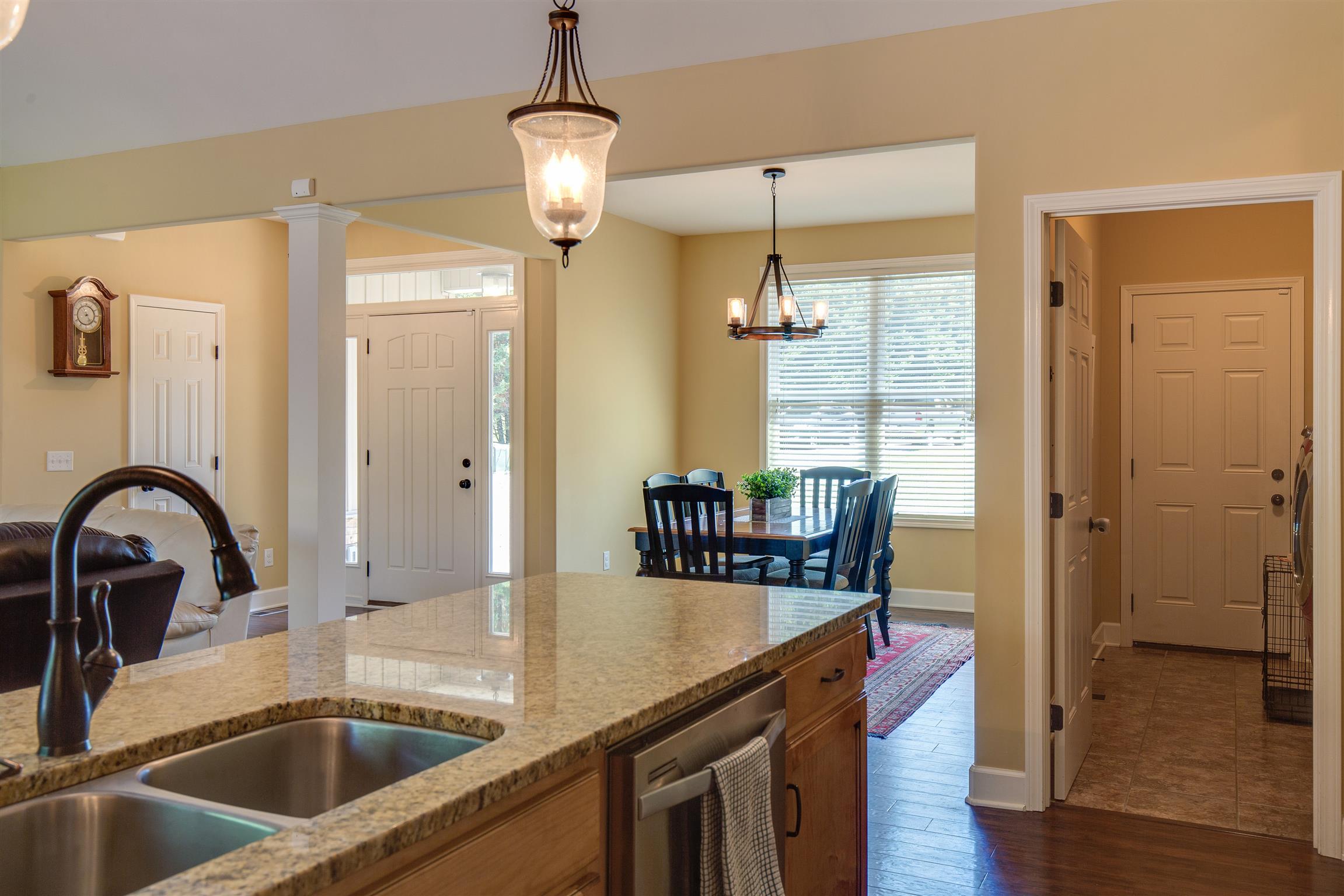 1045 North Corinth Road Portland, TN 37148 - Photo 14 of 29 a kitchen with a sink a faucet a chandelier and living room view