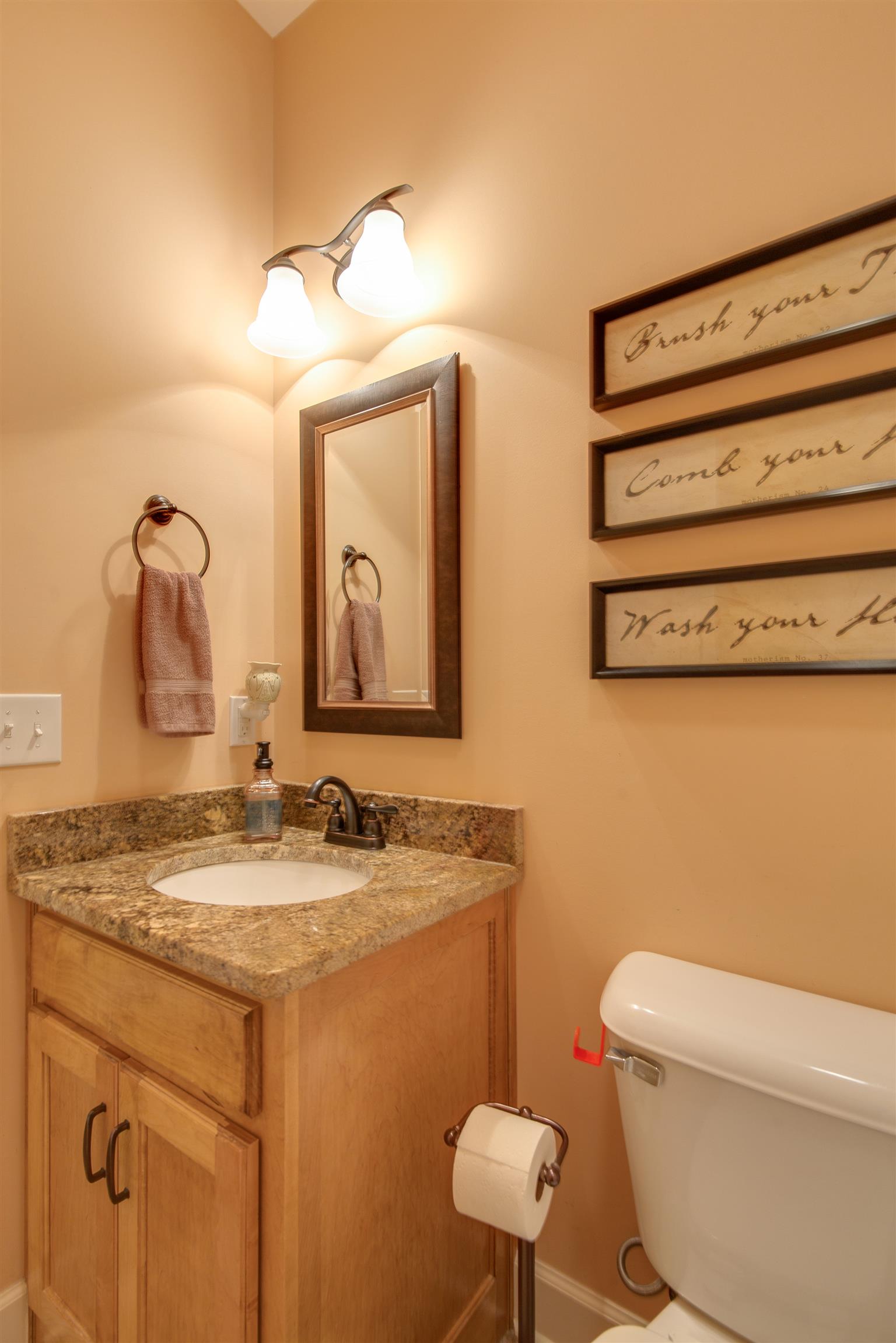 1045 North Corinth Road Portland, TN 37148 - Photo 17 of 29 a bathroom with a granite countertop toilet sink and mirror