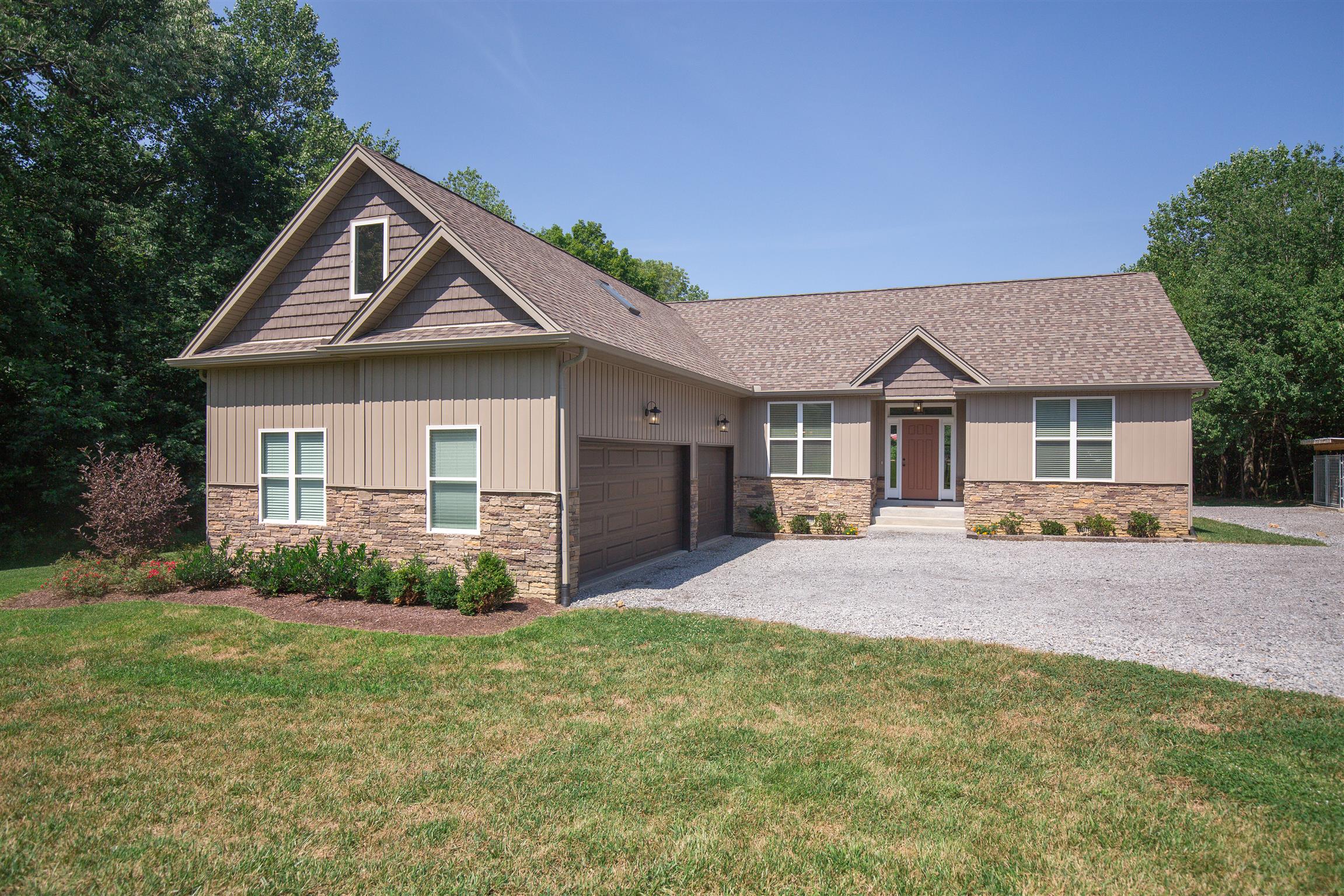 1045 North Corinth Road Portland, TN 37148 - Photo 4 of 29 a front view of a house with a garden