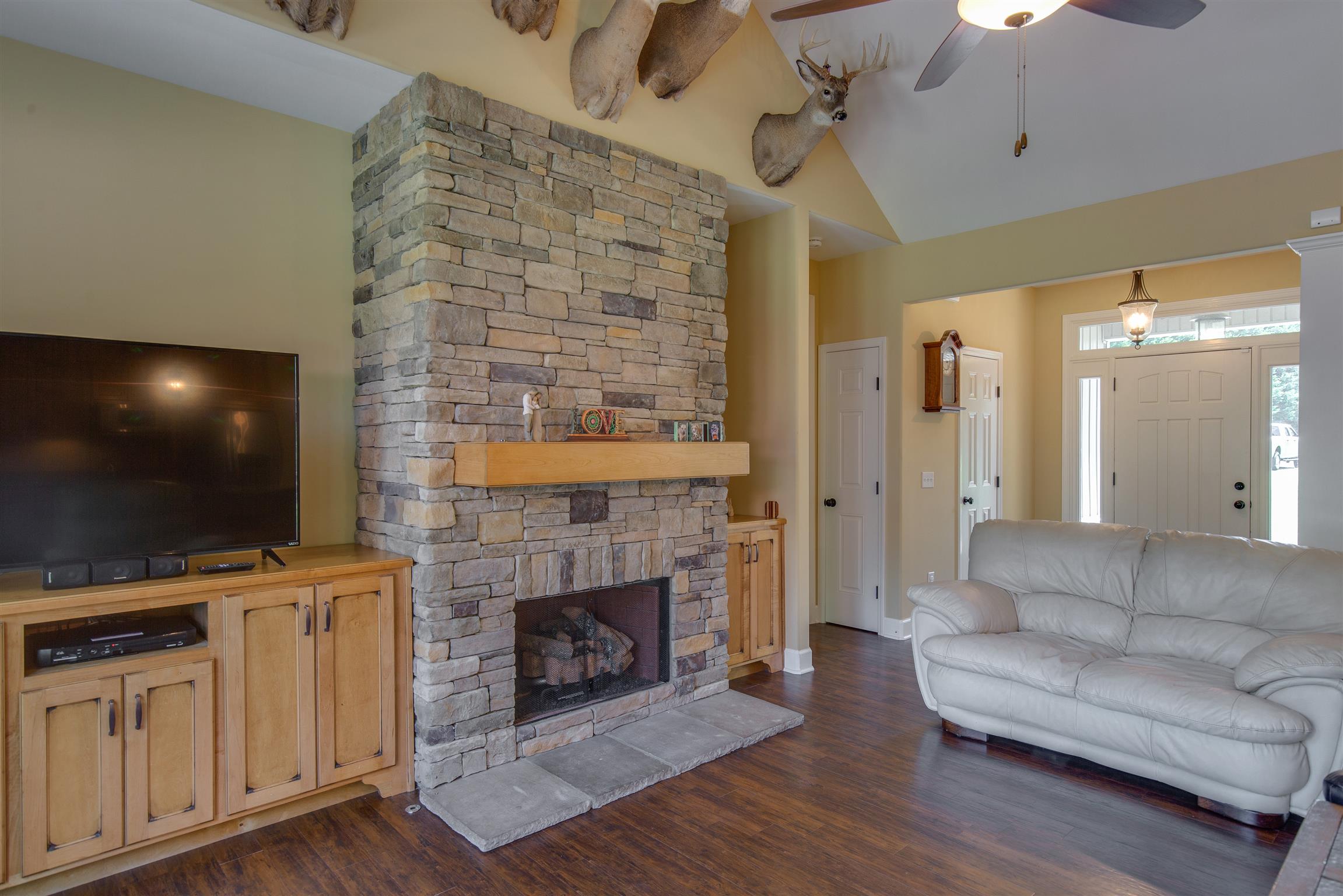 1045 North Corinth Road Portland, TN 37148 - Photo 8 of 29 a living room with furniture a flat screen tv and a fireplace