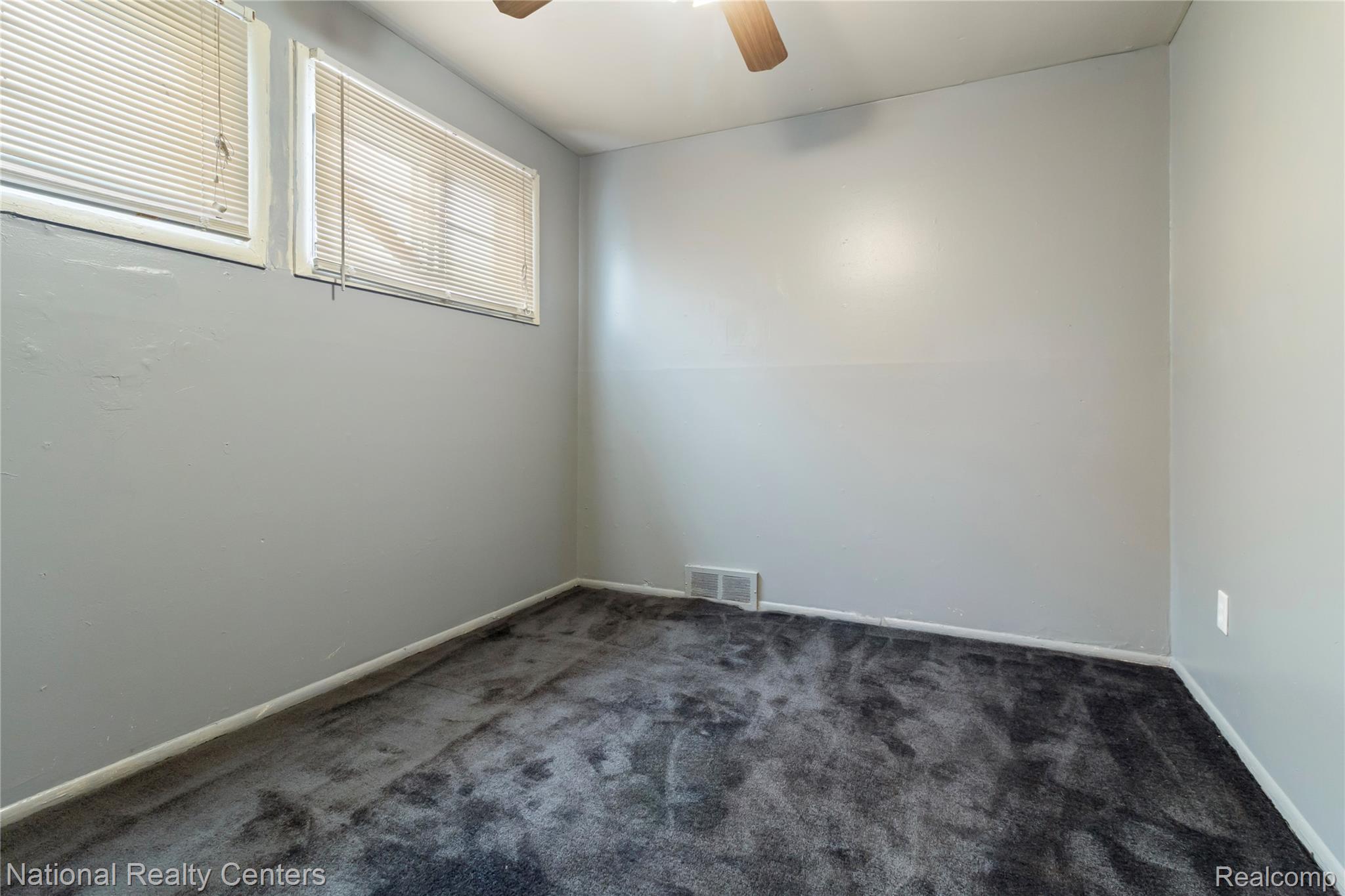 13525 Evergreen Road Detroit, MI 48223 - Photo 15 of 25 Spare room featuring dark carpet and ceiling fan