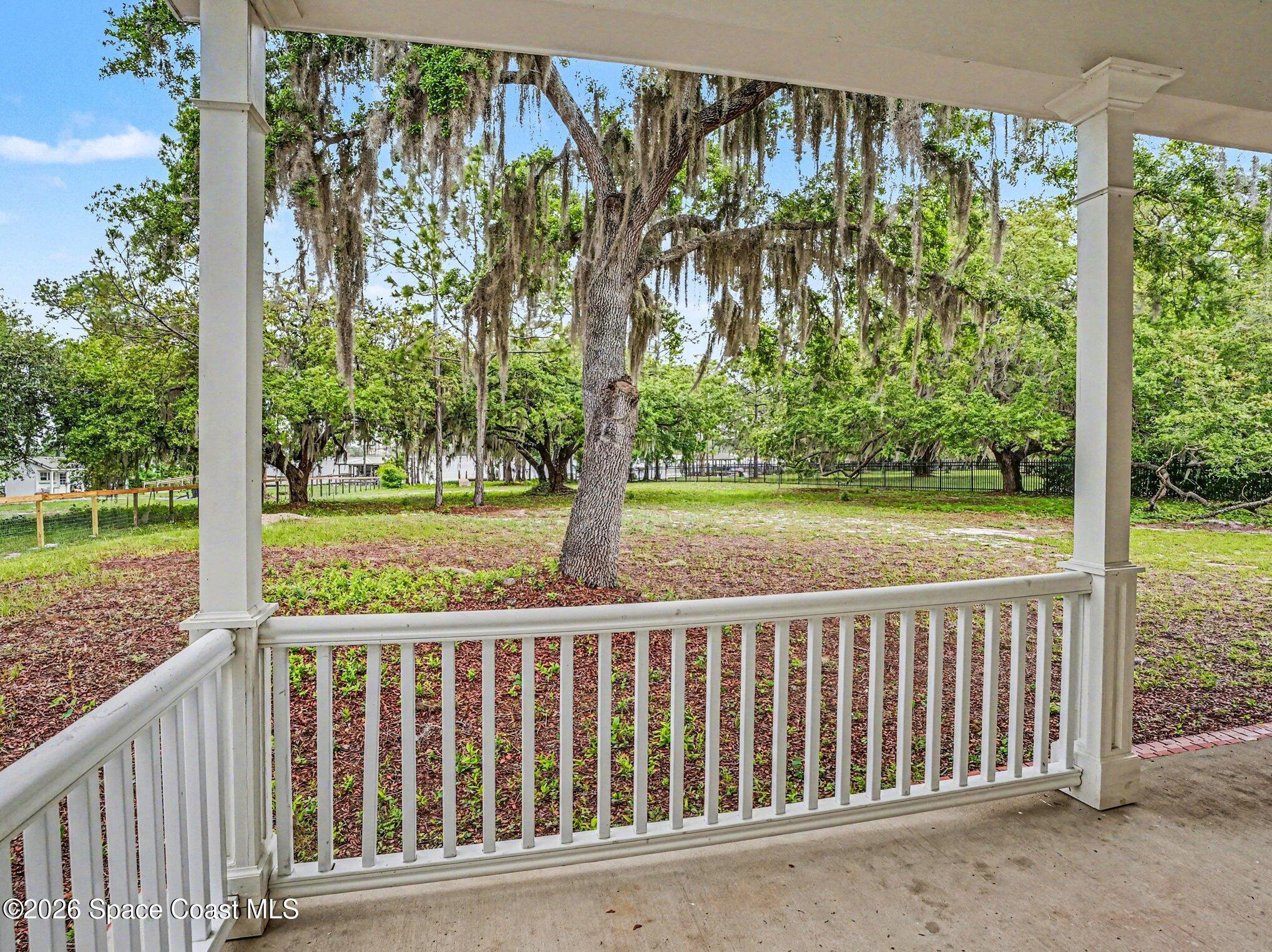 11940 Kirby Smith Road Orlando, FL 32832 - Photo 11 of 39 a porch with a yard in back