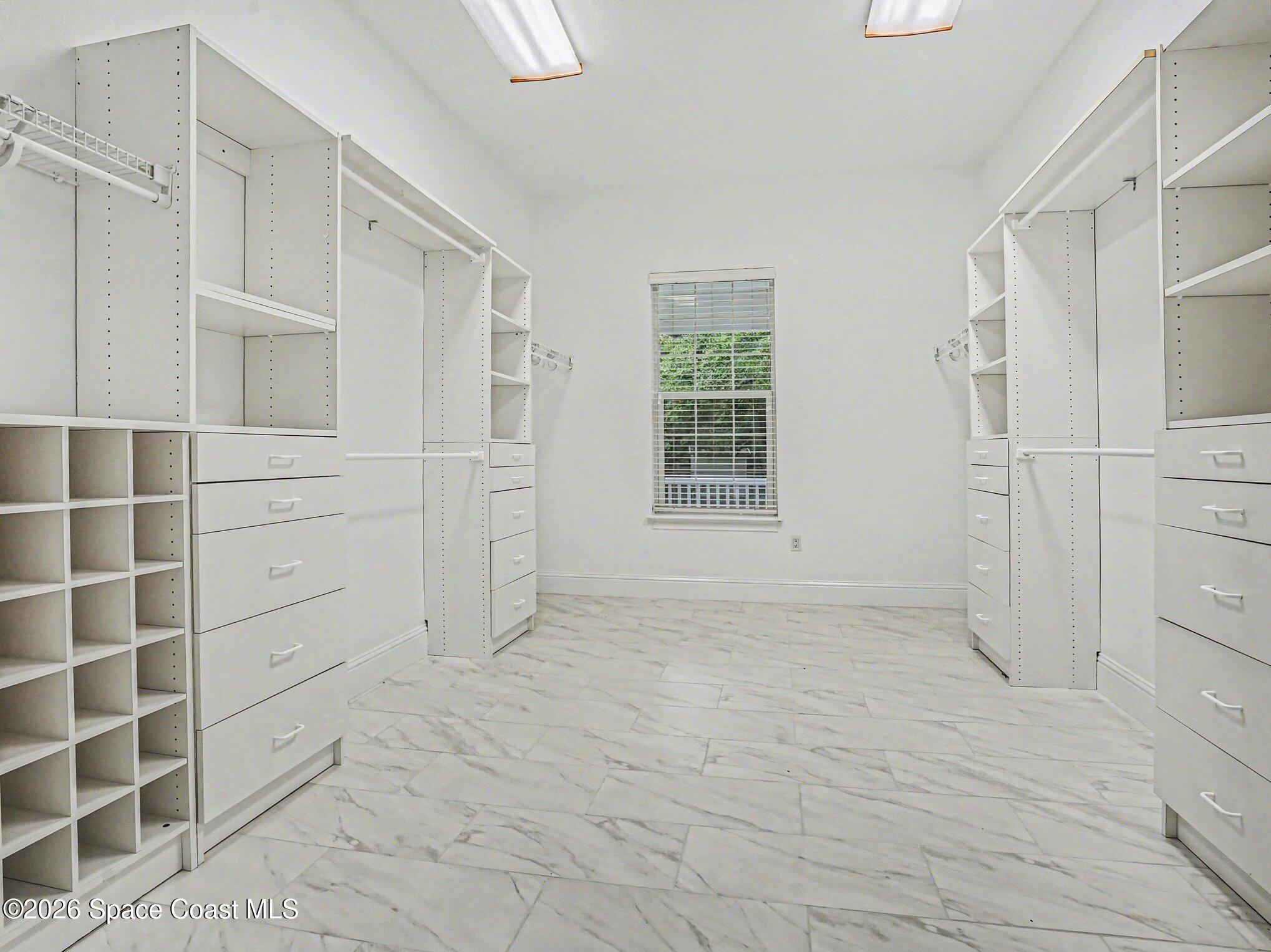 11940 Kirby Smith Road Orlando, FL 32832 - Photo 13 of 39 a view of walk in closet with empty racks