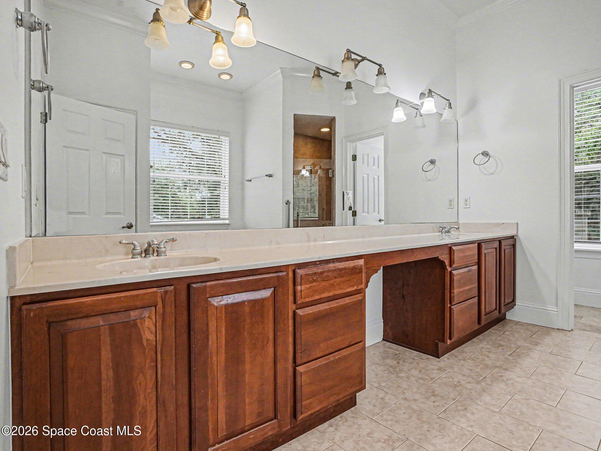 11940 Kirby Smith Road Orlando, FL 32832 - Photo 14 of 39 a spacious bathroom with a granite countertop sink and a large mirror
