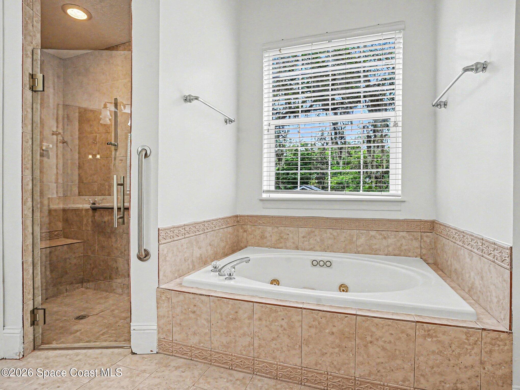 11940 Kirby Smith Road Orlando, FL 32832 - Photo 15 of 39 a white bath tub sitting next to a shower
