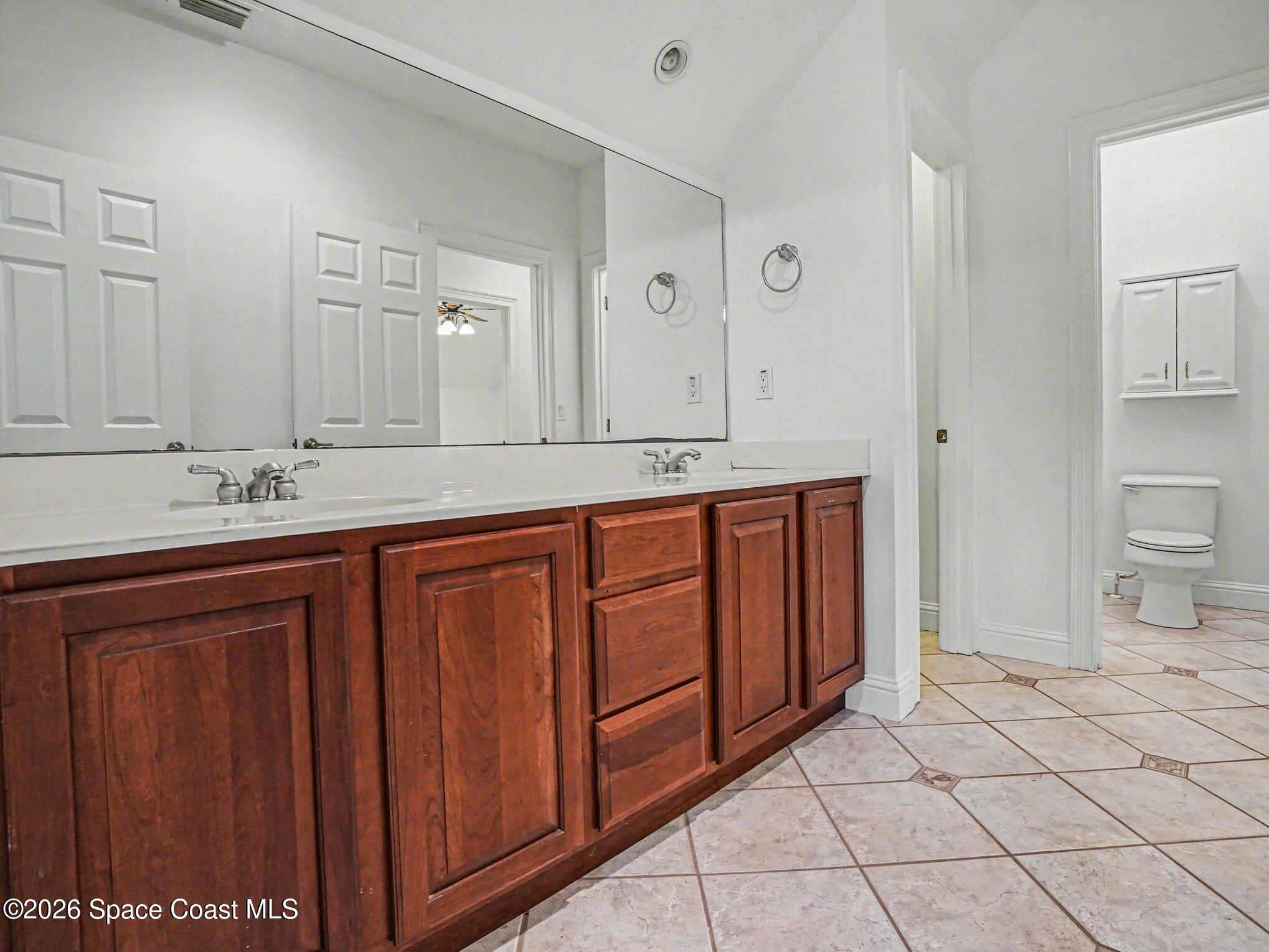 11940 Kirby Smith Road Orlando, FL 32832 - Photo 18 of 39 a bathroom with a sink and a mirror