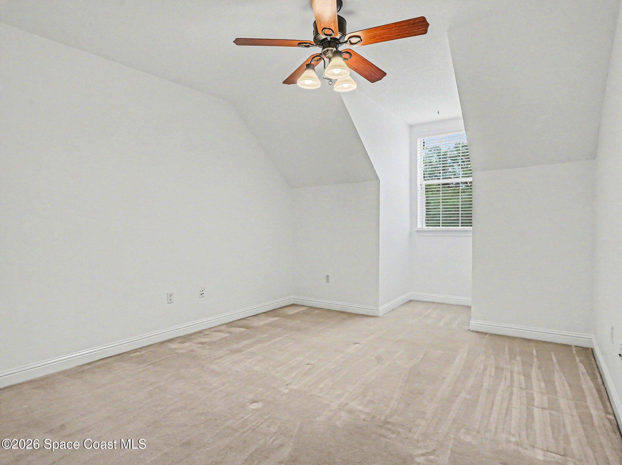 11940 Kirby Smith Road Orlando, FL 32832 - Photo 20 of 39 an empty room with windows and fan