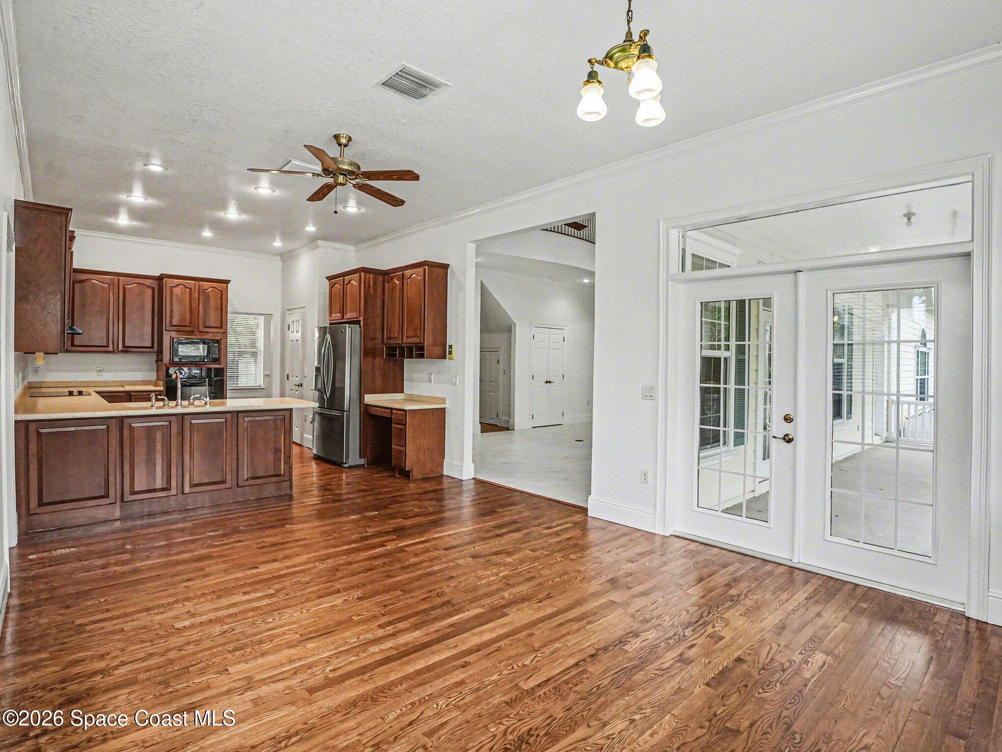 11940 Kirby Smith Road Orlando, FL 32832 - Photo 5 of 39 a view of a kitchen with sink microwave and refrigerator