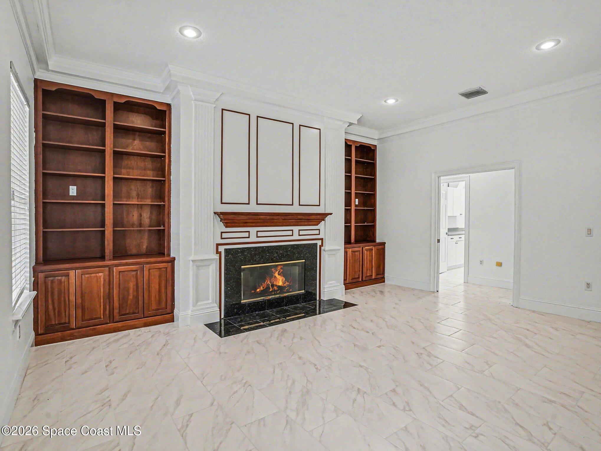 11940 Kirby Smith Road Orlando, FL 32832 - Photo 7 of 39 a view of a livingroom with an empty space and a fireplace