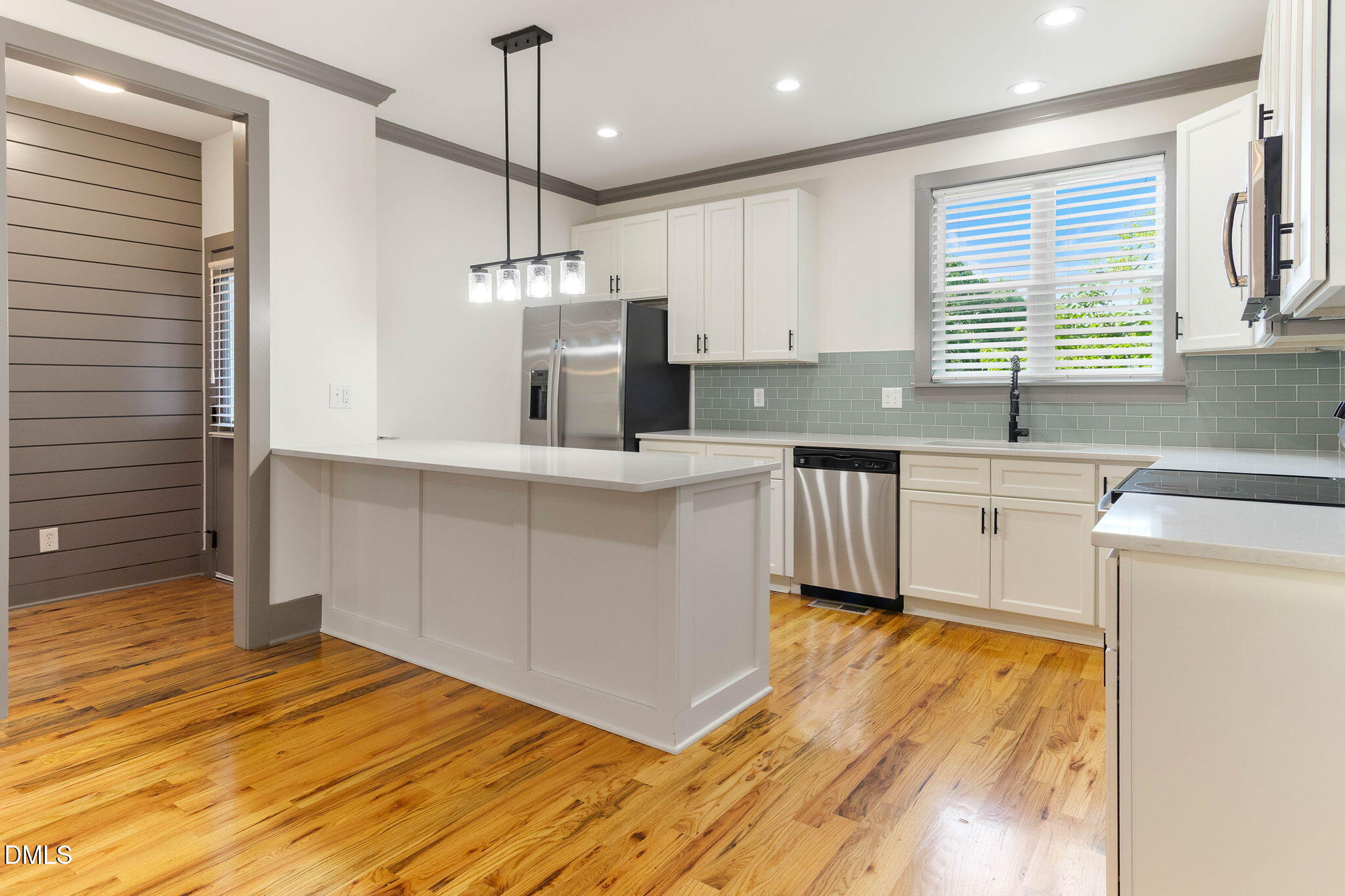 602 Hay Lane Raleigh, NC 27601 - Photo 11 of 43 a kitchen with stainless steel appliances granite countertop a sink a stove a refrigerator cabinets and wooden floor