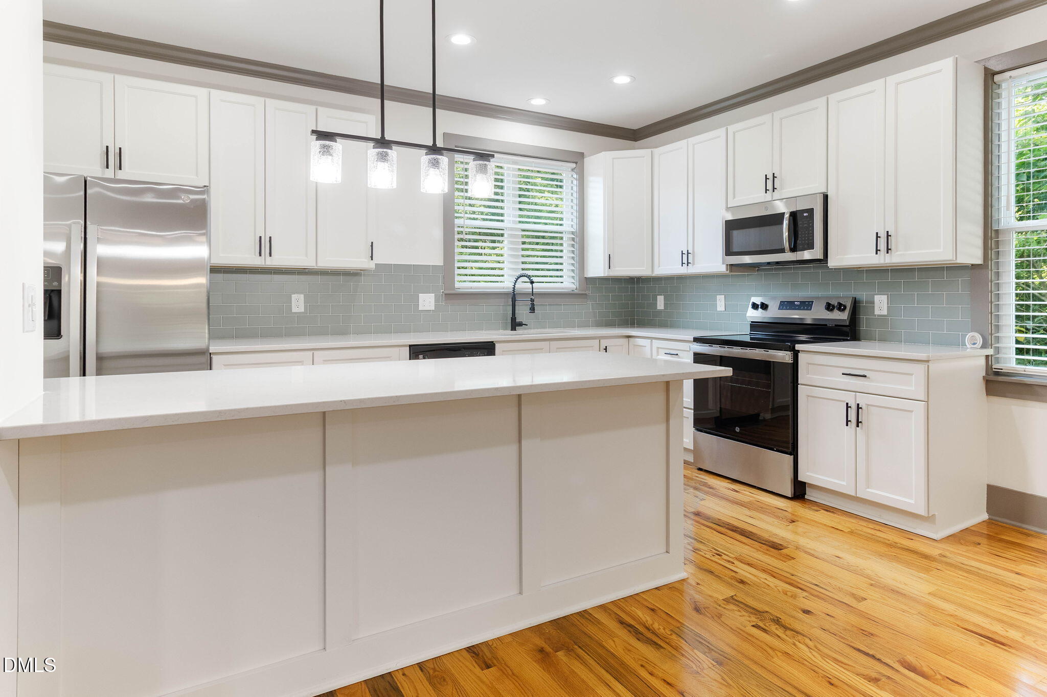 602 Hay Lane Raleigh, NC 27601 - Photo 12 of 43 a kitchen with stainless steel appliances granite countertop a sink a stove a refrigerator and cabinets