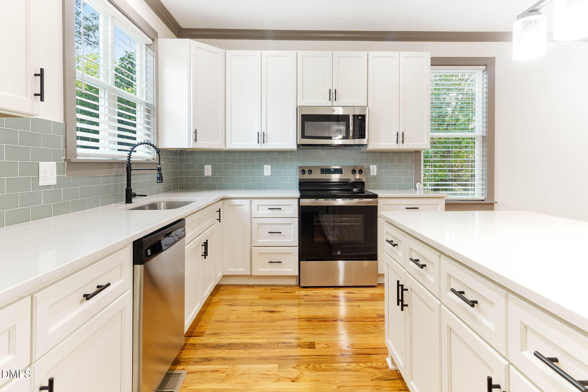 602 Hay Lane Raleigh, NC 27601 - Photo 13 of 43 a kitchen with stainless steel appliances a stove sink microwave and cabinets