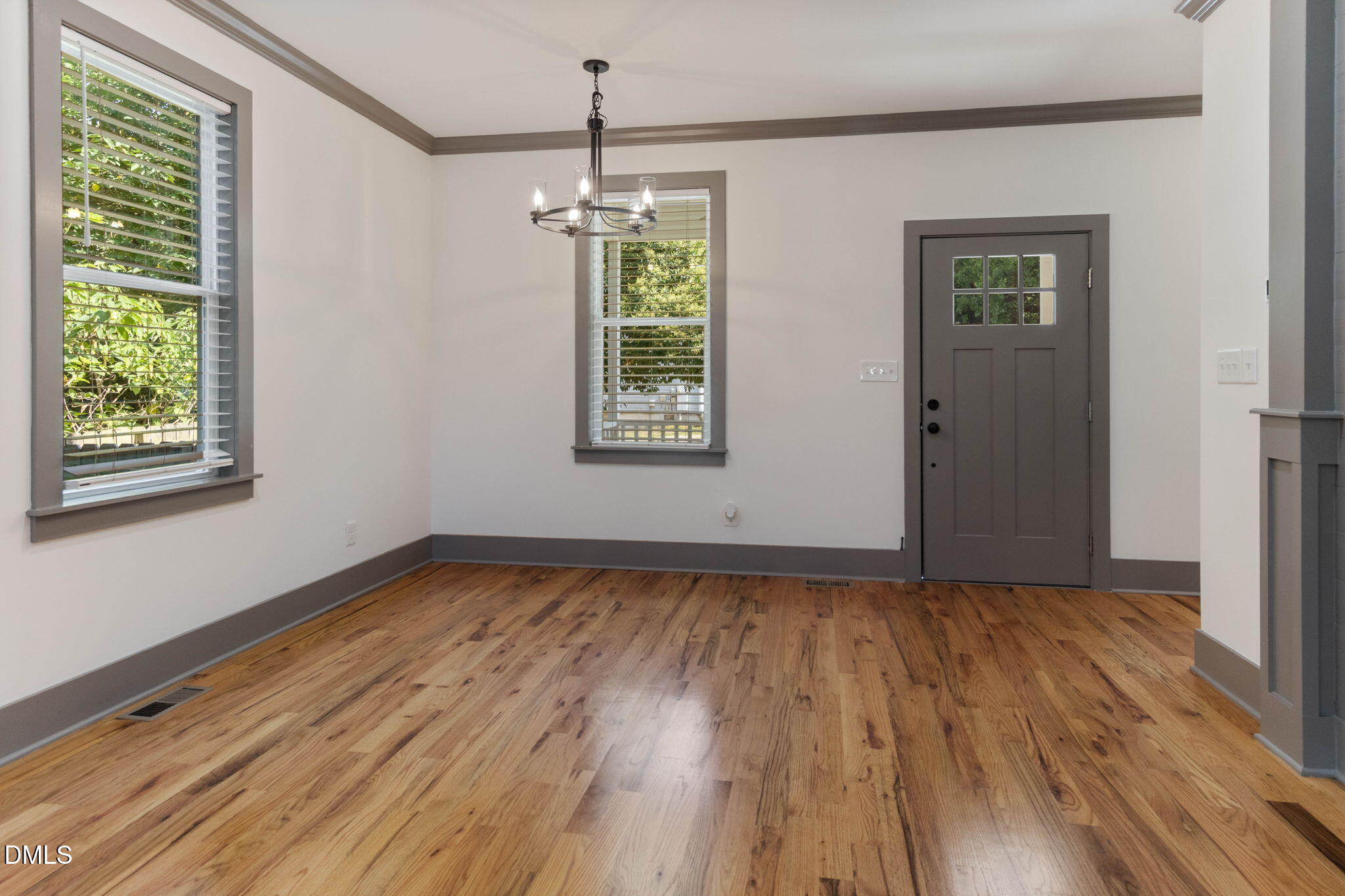 602 Hay Lane Raleigh, NC 27601 - Photo 17 of 43 a view of an empty room with wooden floor and a window