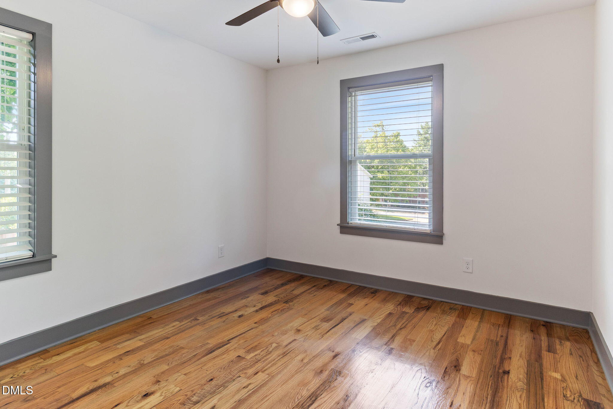 602 Hay Lane Raleigh, NC 27601 - Photo 20 of 43 a view of an empty room with wooden floor and a window