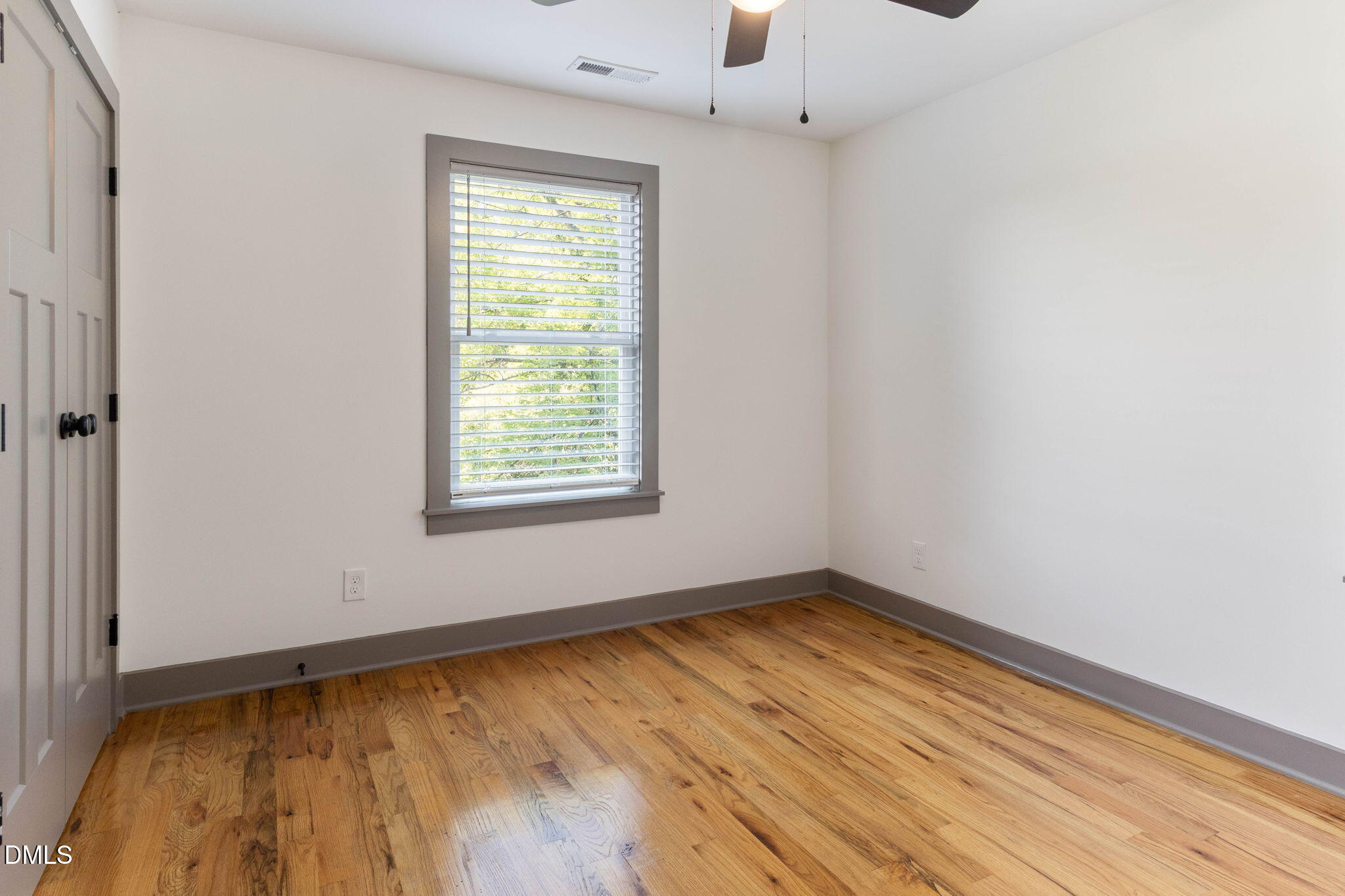 602 Hay Lane Raleigh, NC 27601 - Photo 22 of 43 an empty room with wooden floor and windows