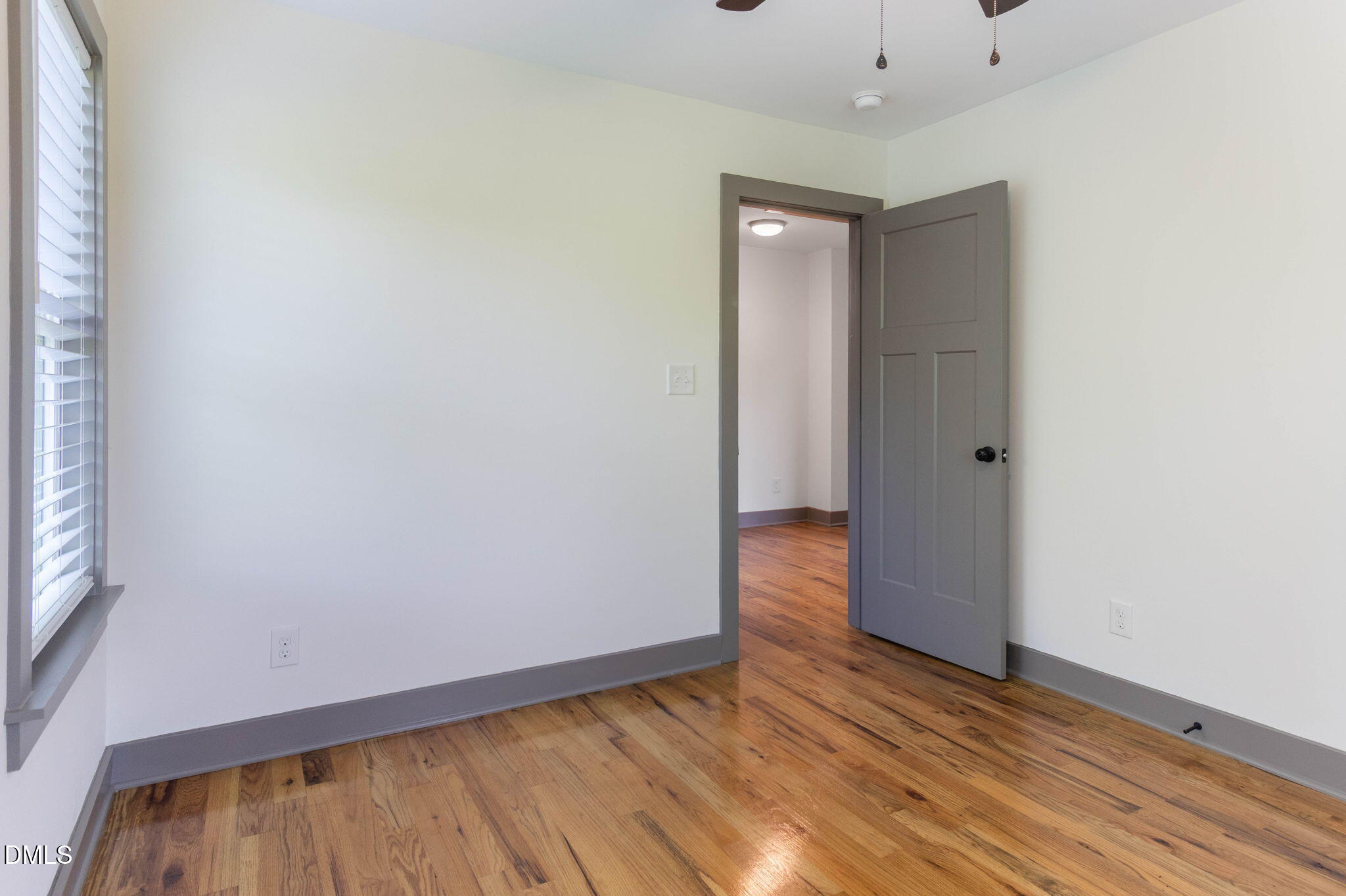 602 Hay Lane Raleigh, NC 27601 - Photo 23 of 43 a view of an empty room with wooden floor and a window