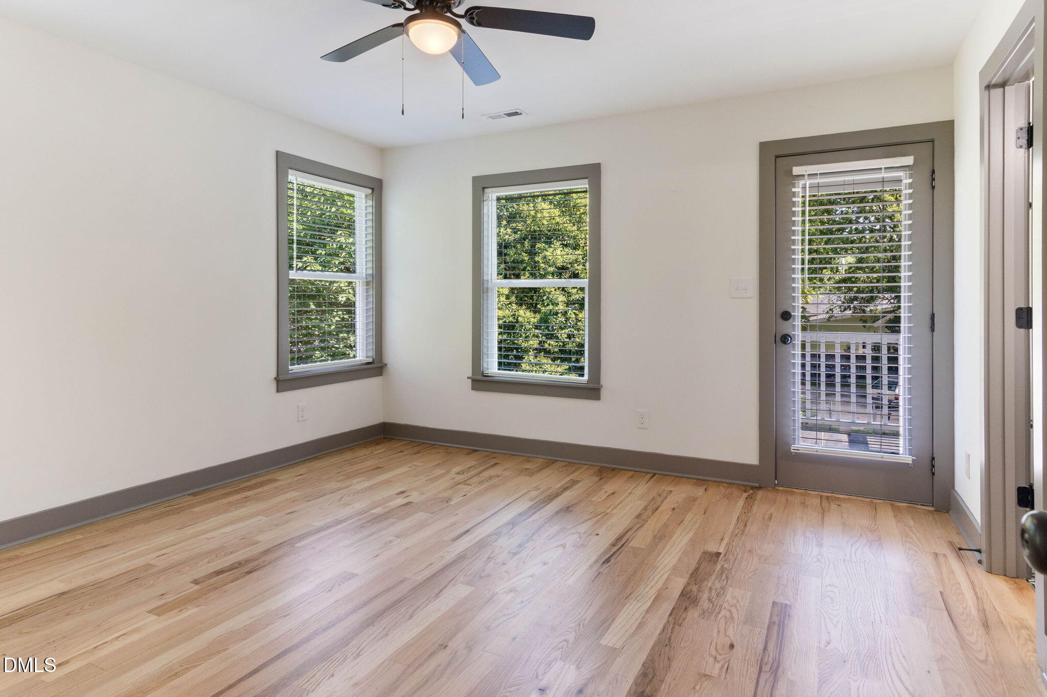 602 Hay Lane Raleigh, NC 27601 - Photo 26 of 43 a view of an empty room with wooden floor and a window