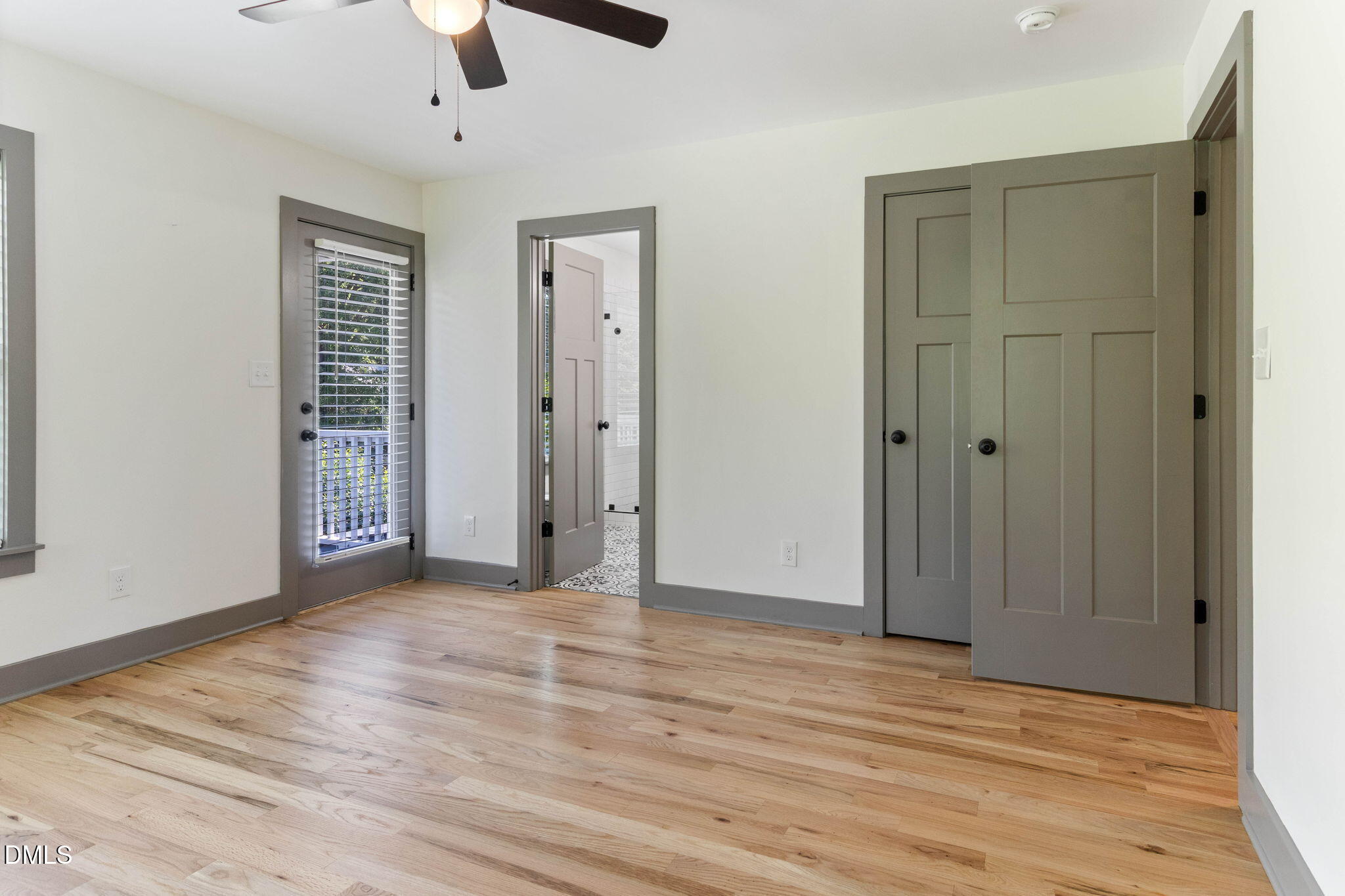 602 Hay Lane Raleigh, NC 27601 - Photo 27 of 43 a view of an empty room with wooden floor and a ceiling fan