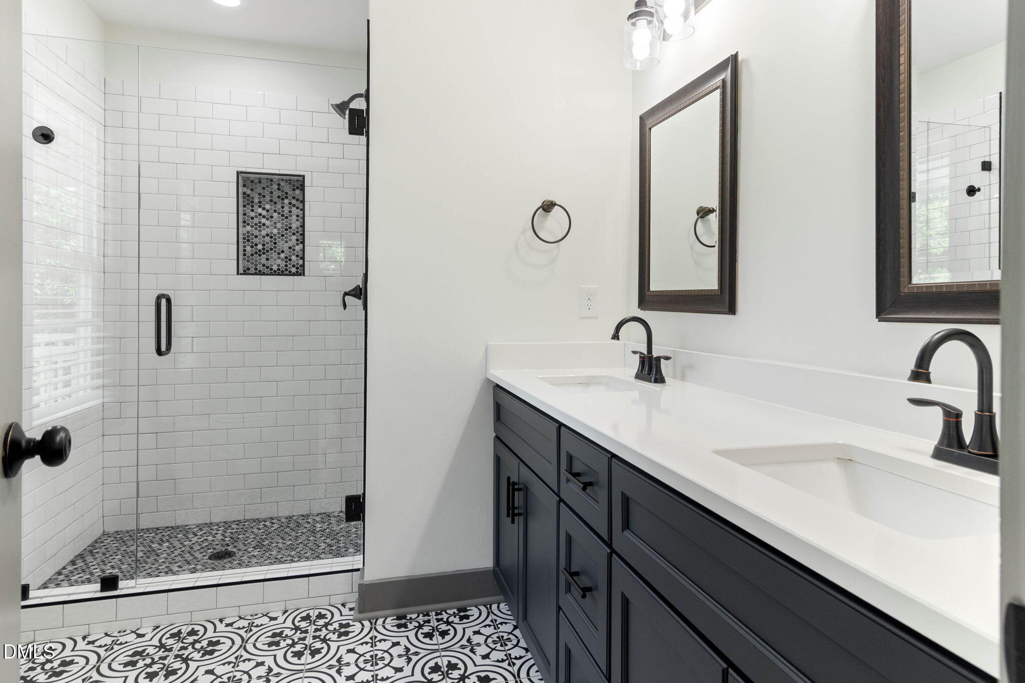 602 Hay Lane Raleigh, NC 27601 - Photo 29 of 43 a bathroom with a shower sink and mirror