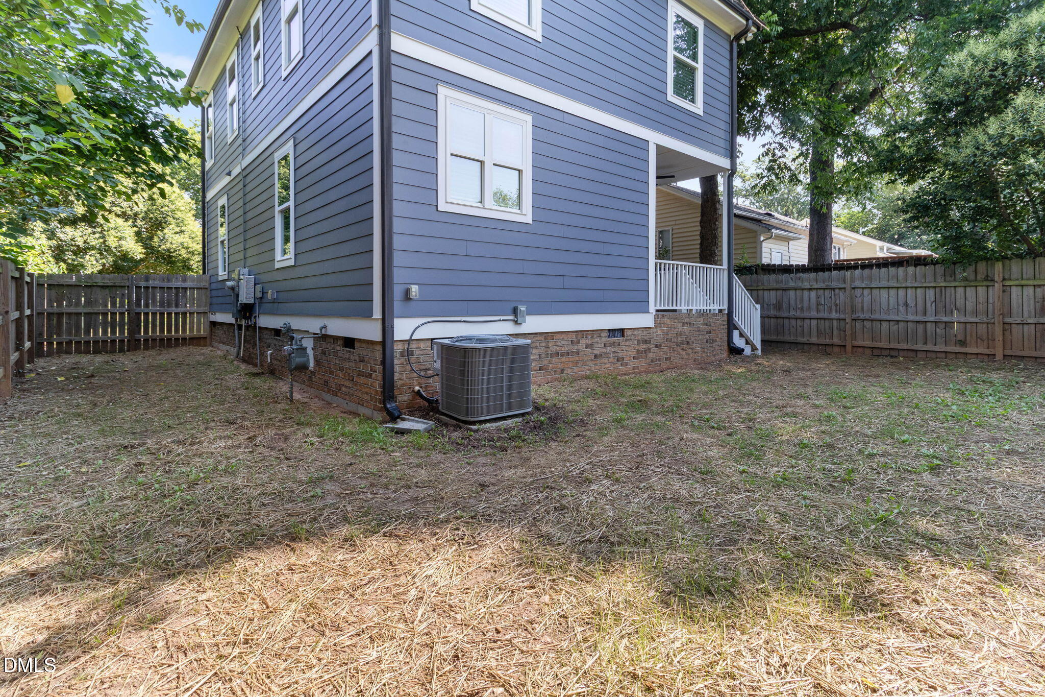 602 Hay Lane Raleigh, NC 27601 - Photo 35 of 43 a backyard of a house with wooden fence and a tree