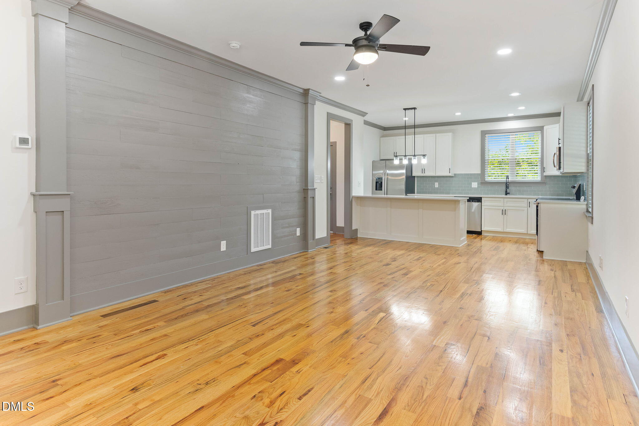 602 Hay Lane Raleigh, NC 27601 - Photo 8 of 43 a view of a kitchen with kitchen island a sink stainless steel appliances and cabinets