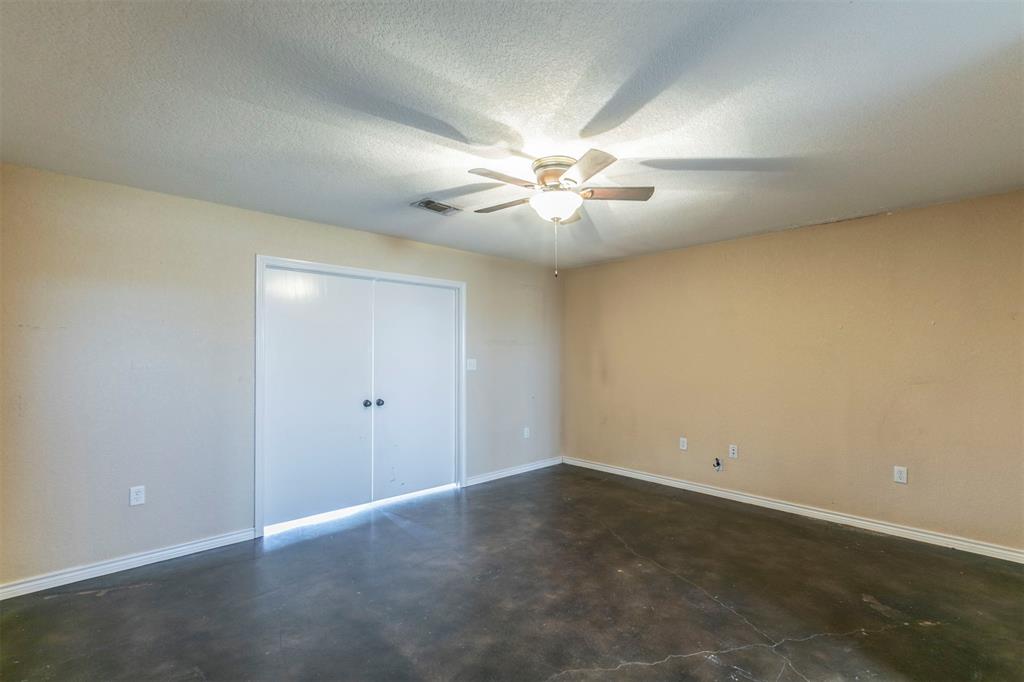 32471 Highway 108 Mingus, TX 76463 - Photo 13 of 40 Unfurnished bedroom featuring a textured ceiling, visible vents, baseboards, a closet, and finished concrete floors