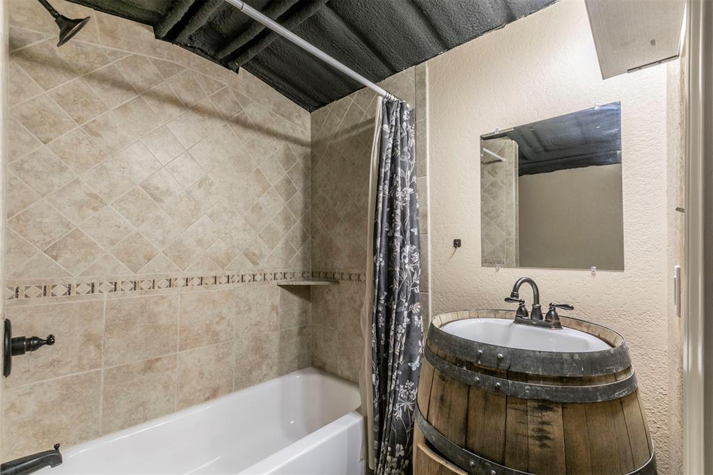 32471 Highway 108 Mingus, TX 76463 - Photo 24 of 40 Full bathroom featuring shower / tub combo, a textured wall, and vanity
