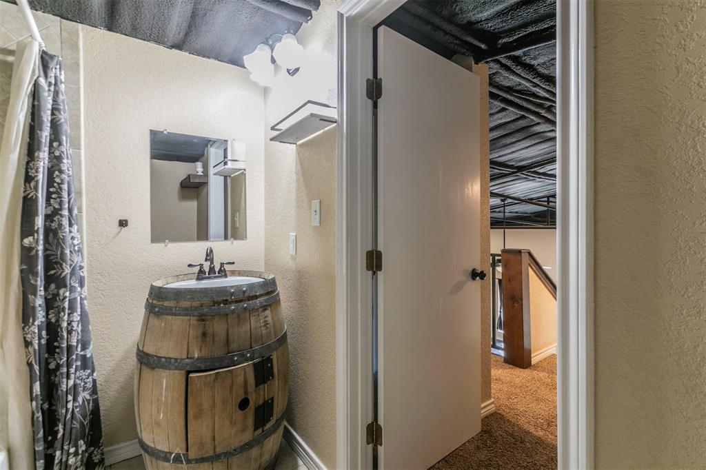 32471 Highway 108 Mingus, TX 76463 - Photo 25 of 40 Bathroom featuring vanity and a textured wall
