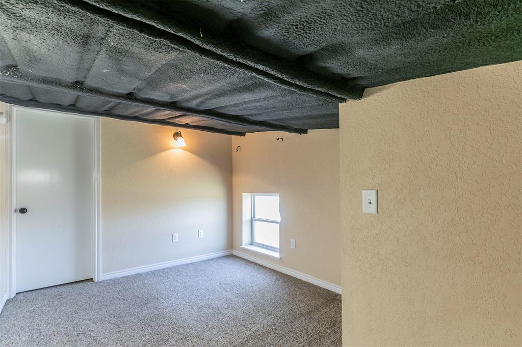 32471 Highway 108 Mingus, TX 76463 - Photo 27 of 40 Unfurnished room featuring a textured wall, carpet flooring, and baseboards