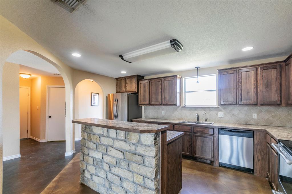 32471 Highway 108 Mingus, TX 76463 - Photo 7 of 40 Kitchen with stainless steel appliances, visible vents, a sink, and backsplash