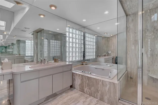 a large bathroom with a large tub sink and vanity