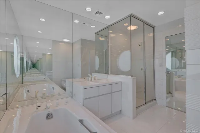 a bathroom with a double vanity sink mirror and shower