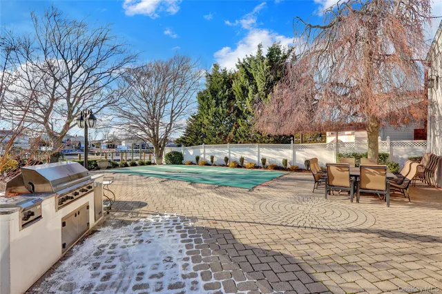 a view of a backyard with table and chairs