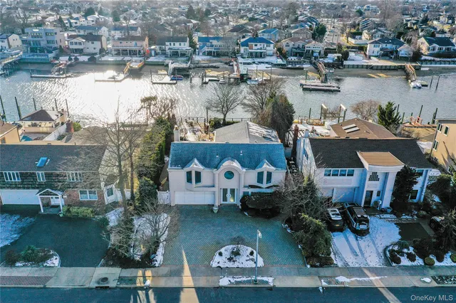 an aerial view of a house with outdoor space and lake view