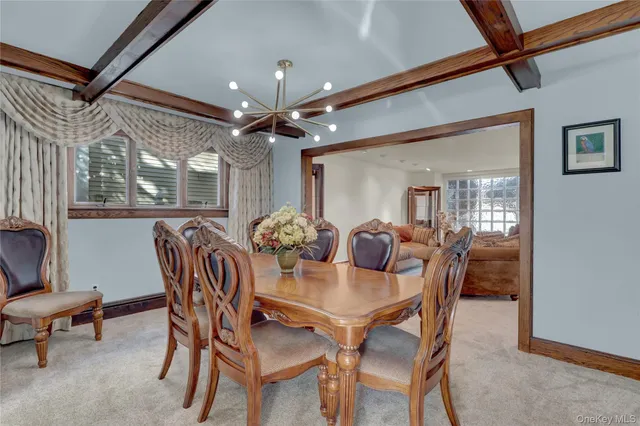 a view of a dining room with furniture and chandelier