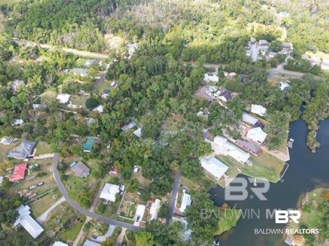 0 Coopers Landing Road Foley, AL 36535 - Photo 4 of 9 Aerial view of property's location featuring nearby suburban area and a heavily wooded area