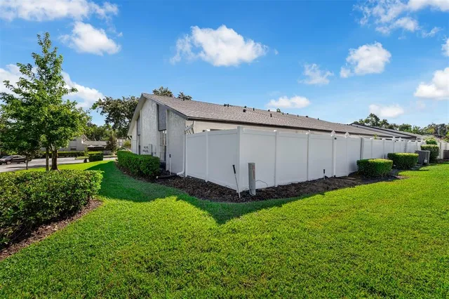 a view of a back yard of the house with a yard