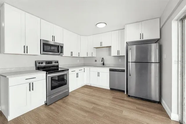 a kitchen with a refrigerator stove and microwave