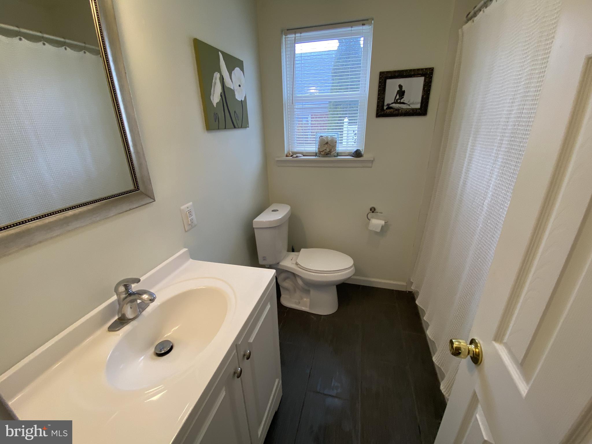 13 Brookside Road Glenside, PA 19038 - Photo 10 of 22 a bathroom with a sink and mirror with toilet