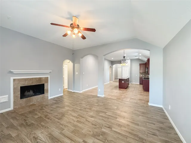 a view of a livingroom with a fireplace and window