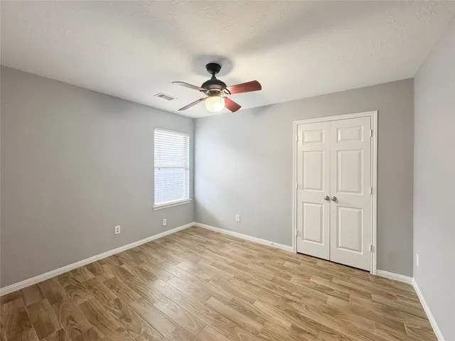 a view of room with a ceiling fan and window