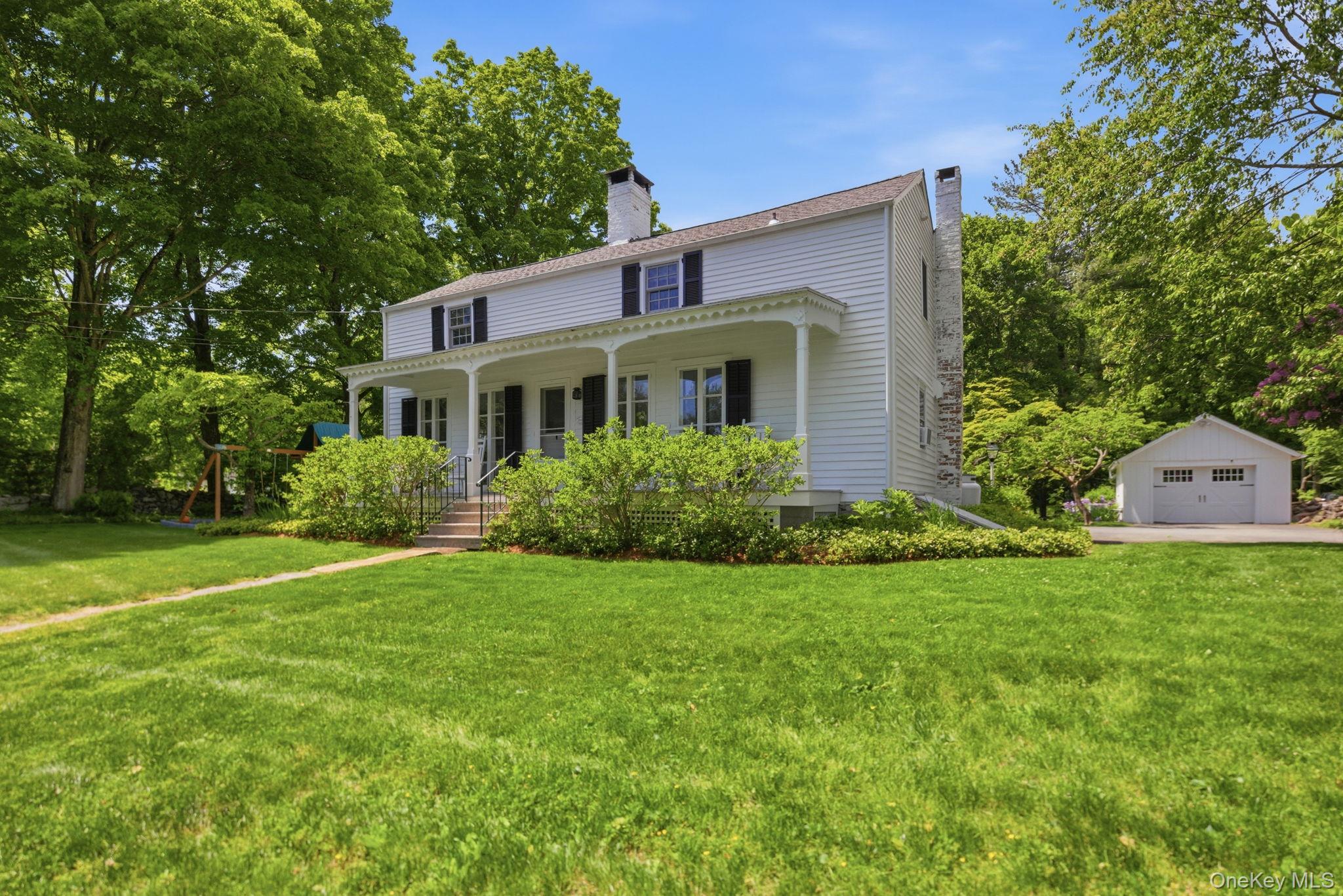 23 Pound Ridge Road Pound Ridge, NY 10576 - Photo 2 of 40 a front view of a house with a yard and trees