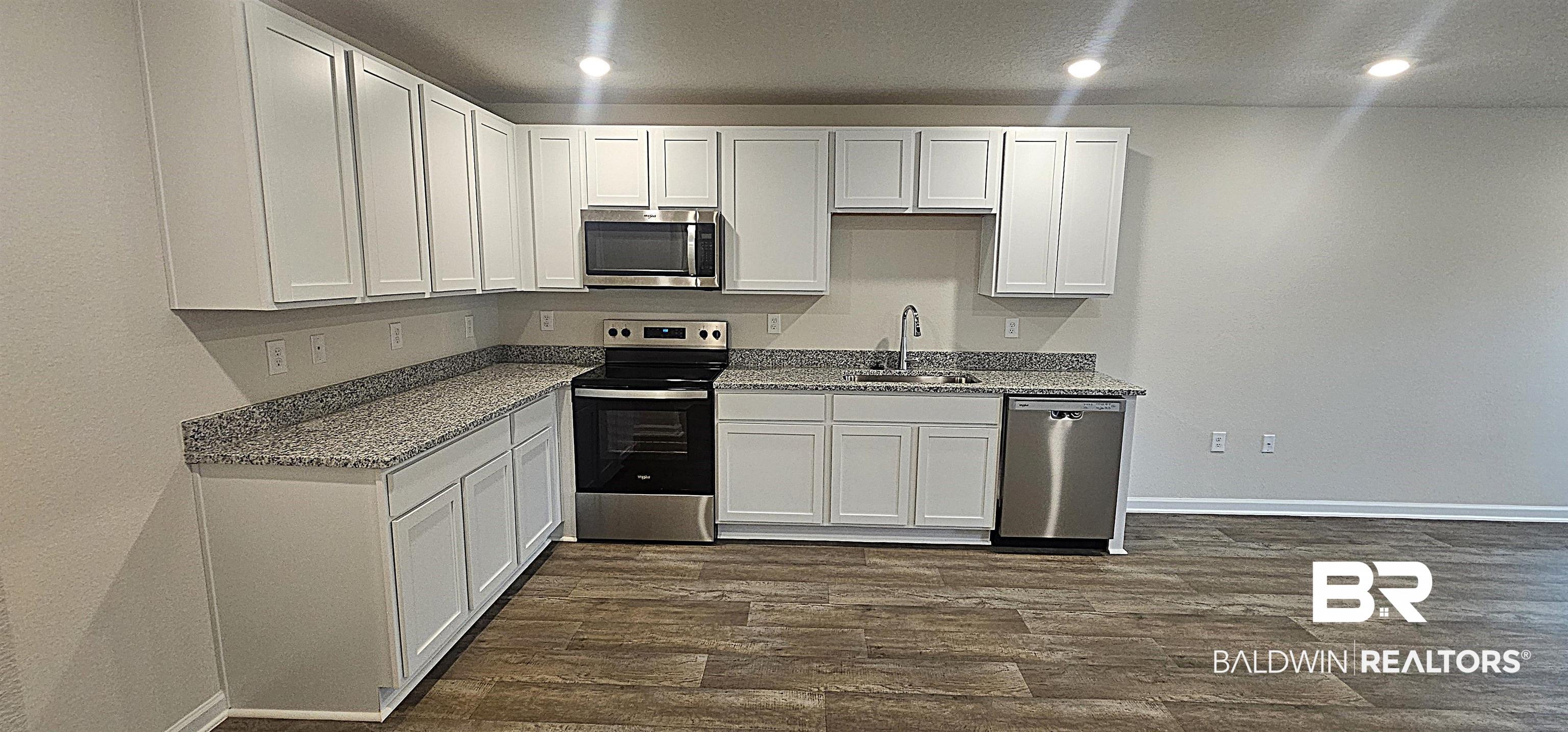 1148 Sweet Laurel Street Foley, AL 36535 - Photo 10 of 18 Kitchen featuring white cabinetry, stainless steel appliances, and sink