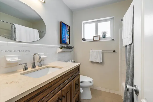 a bathroom with a sink toilet and mirror