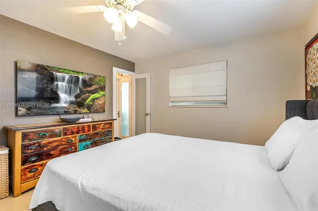 a bedroom with a bed and dresser