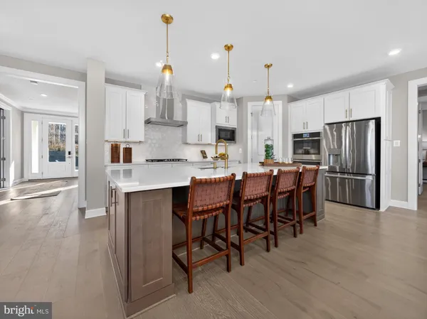 a large kitchen with a table and chairs