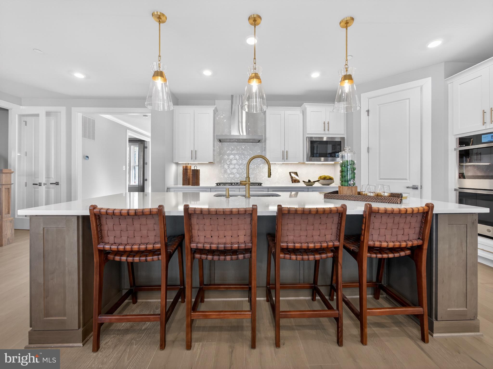 167 Brazier Lane Exton, PA 19341 - Photo 9 of 48 a dining area with a table chairs and a kitchen view