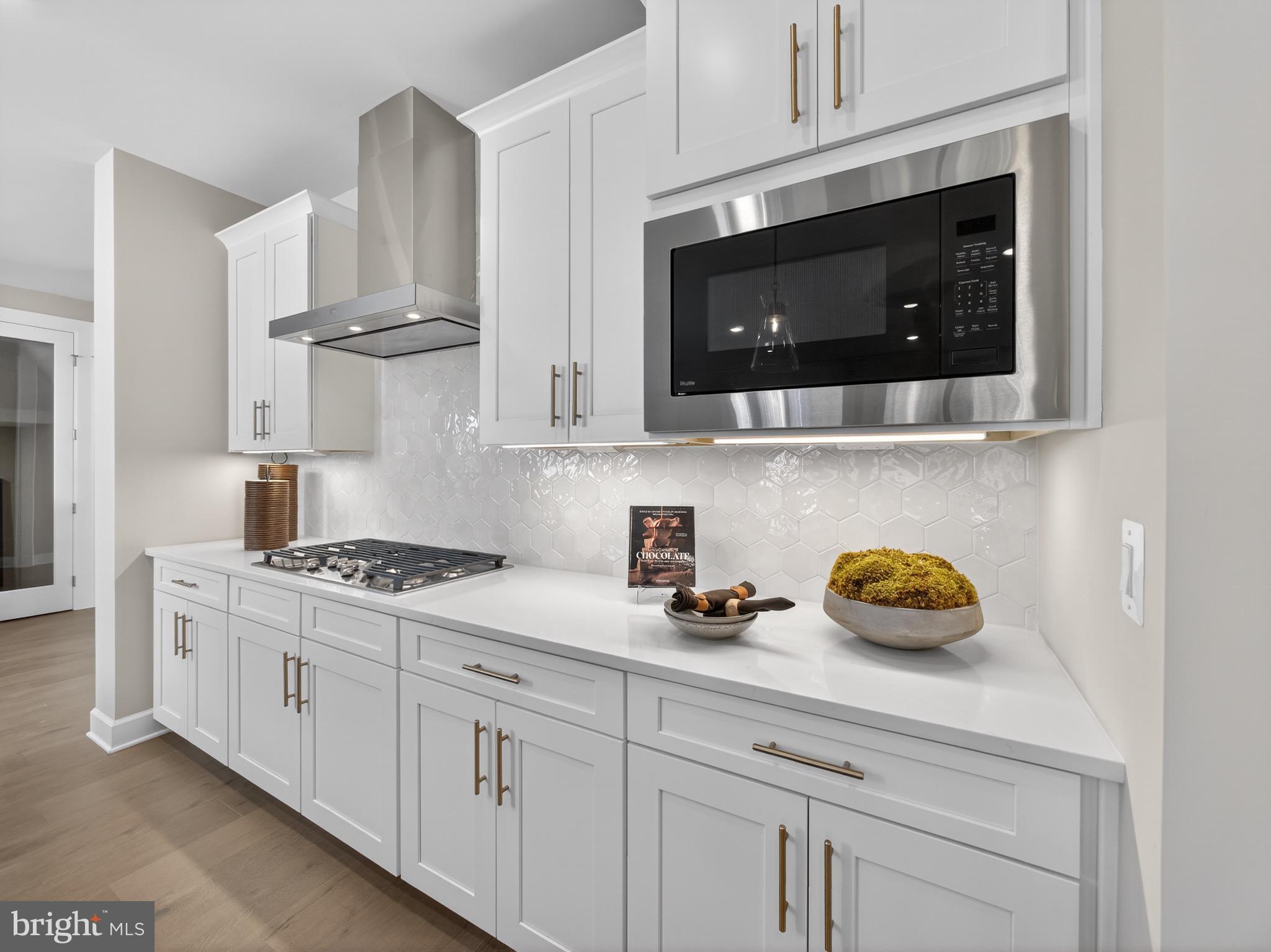 167 Brazier Lane Exton, PA 19341 - Photo 10 of 48 a kitchen with stainless steel appliances a stove a microwave and cabinets