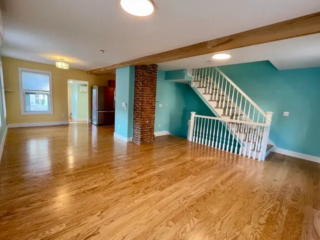 a view of a room with wooden floor