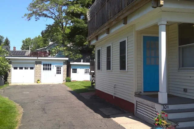 an aerial view of a house with a garden and yard